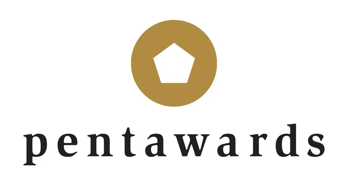 Logotipo de los Pentawards con una figura pentagonal blanca dentro de un círculo dorado y la palabra 'pentawards' en letras negras debajo.