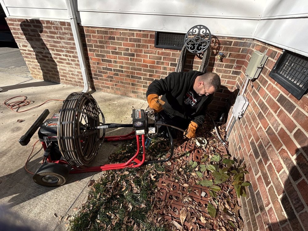 Outdoor drain line cleaning with a cable machine