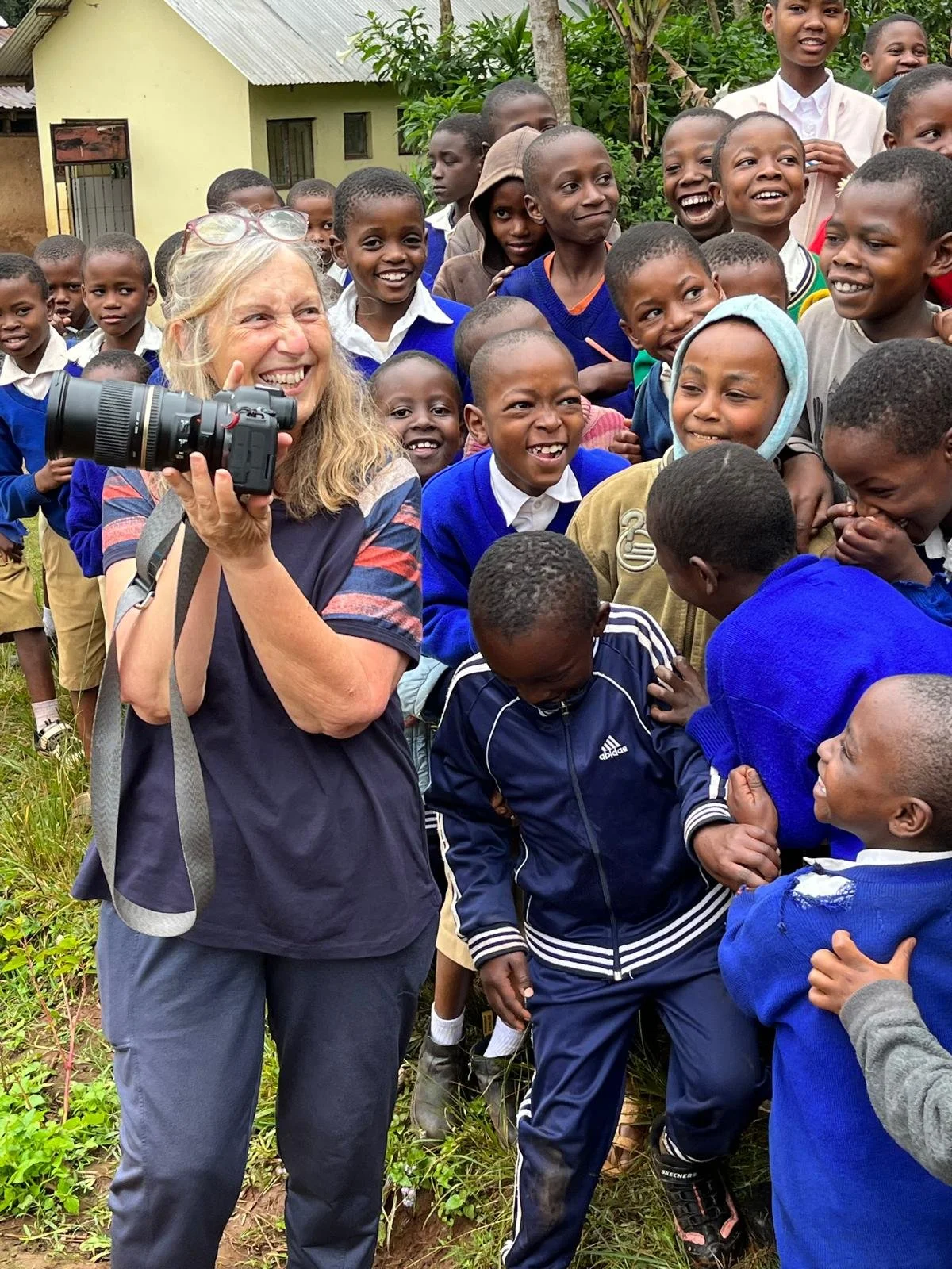 Wildlife photographer Fabiana Carmeli with a group of children while visiting a school in Tanzania.