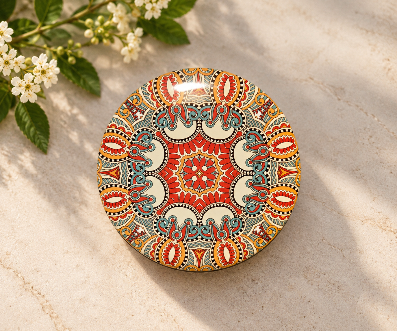 Beautiful Bohemian patterned tin of Mind Your Own Beeswax hand balm photographed outdoors in natural light.