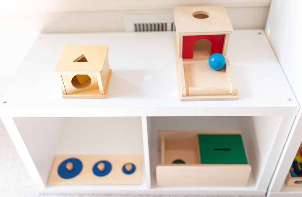 montessori toys on white shelf