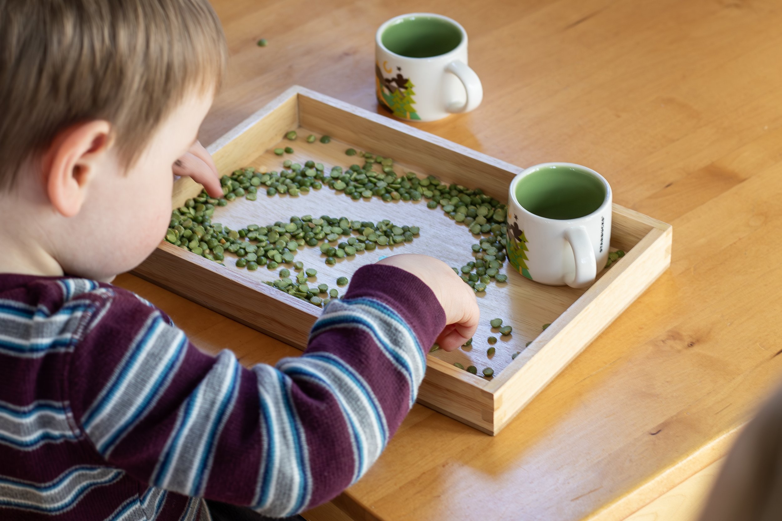 boy playing with low-stimulation montessori toys