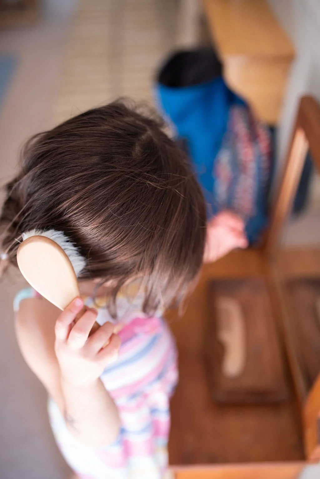 child buttering a cracker