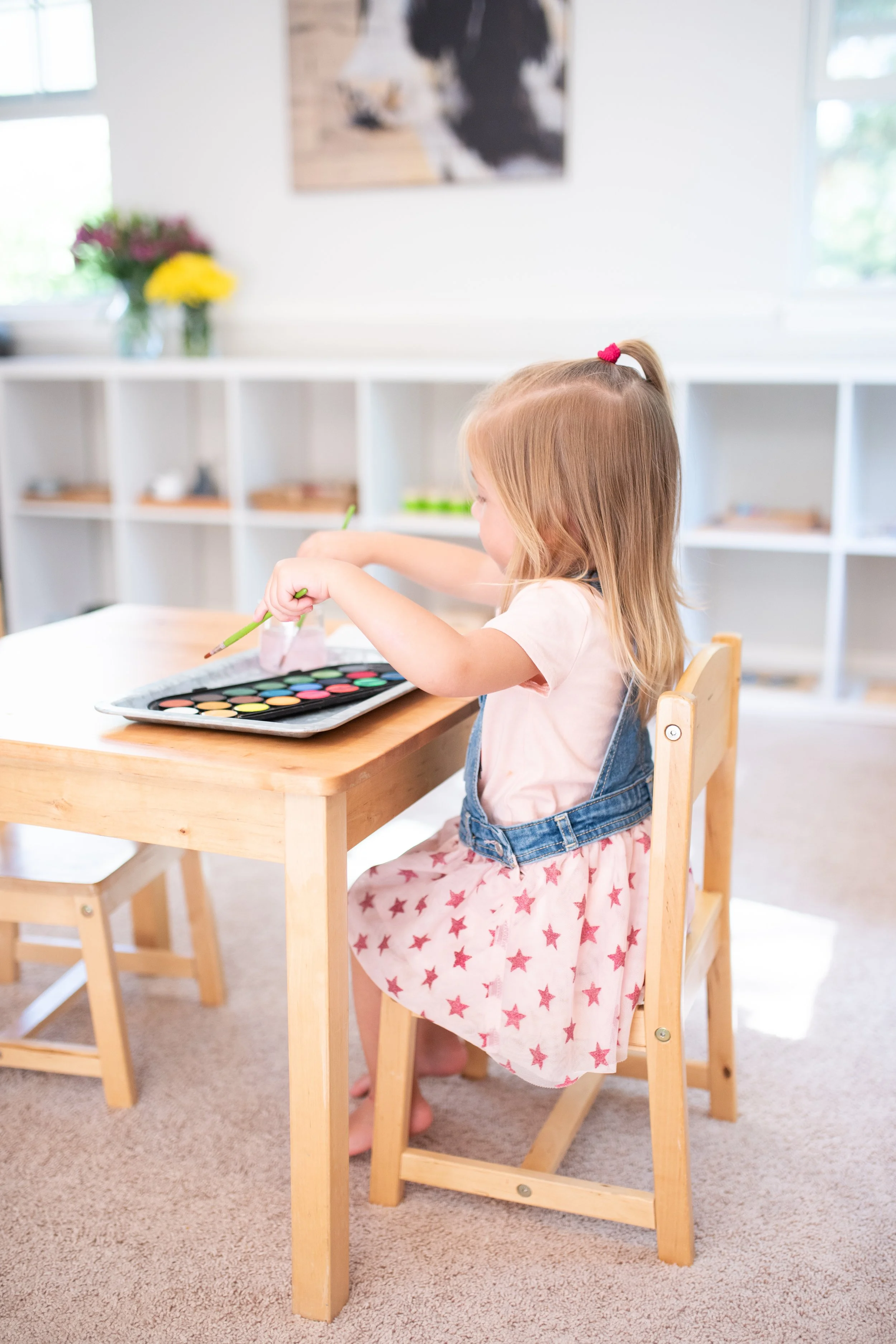 girl painting at table