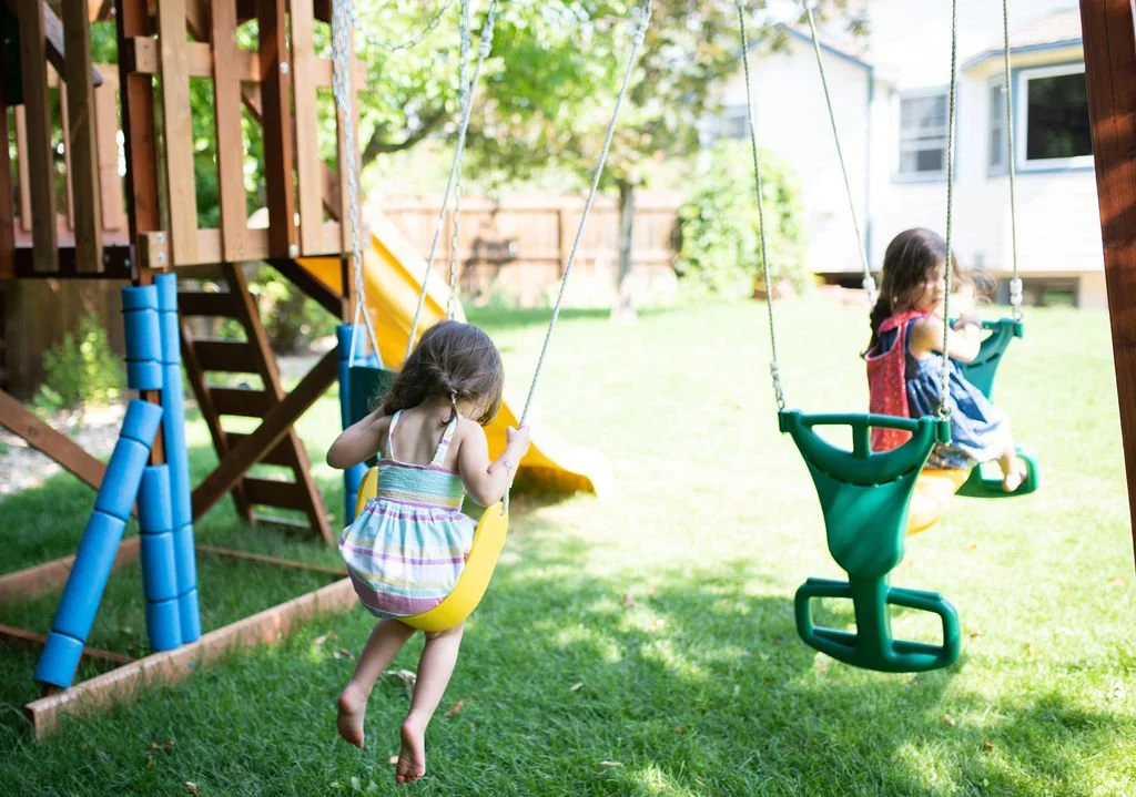 children swinging in the yard
