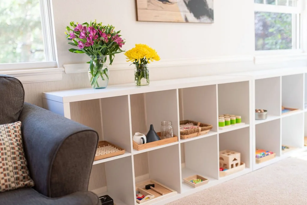 shelf of toys and comfy chair