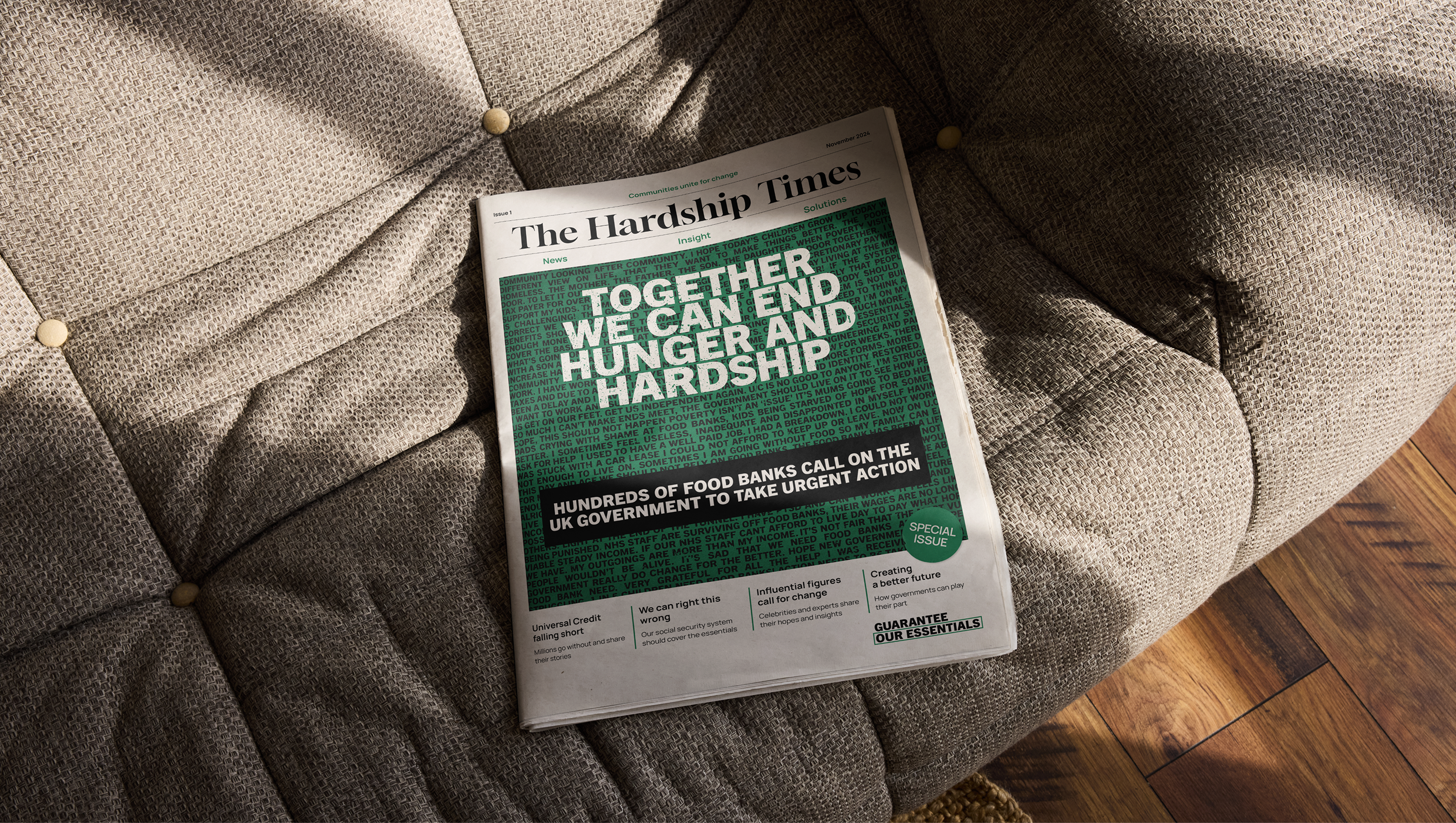 The image shows a newspaper on a sofa, with a green background on the front cover. It has text on it that reads 'Together we can end hunger and hardship'