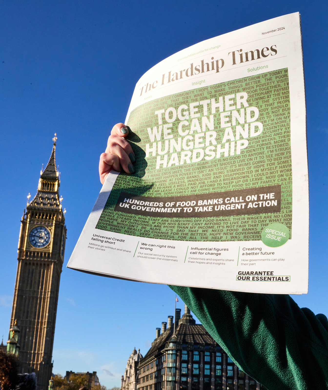 Someone is holding up a newspaper, with Big Ben in the background. The paper has a green background on the front page, and text that reads 'Together we can end hunger and hardship'