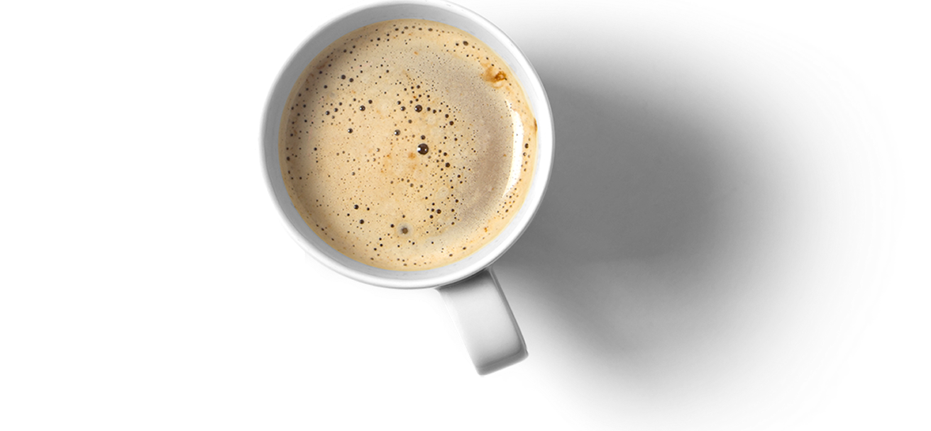 A mug of coffee is photographed from abvove, so it looks flat on the page. It has lots of foam in it, like a latte or cappucino.