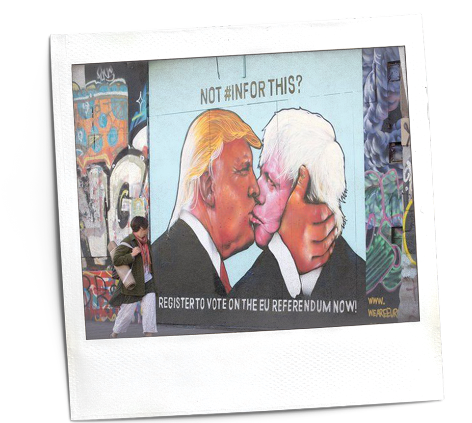 A polaroid picture showing a mural on a wall, with someone walking past it. The mural shows trump and boris johnson, with the words 'register to vote on the eu referendum now'