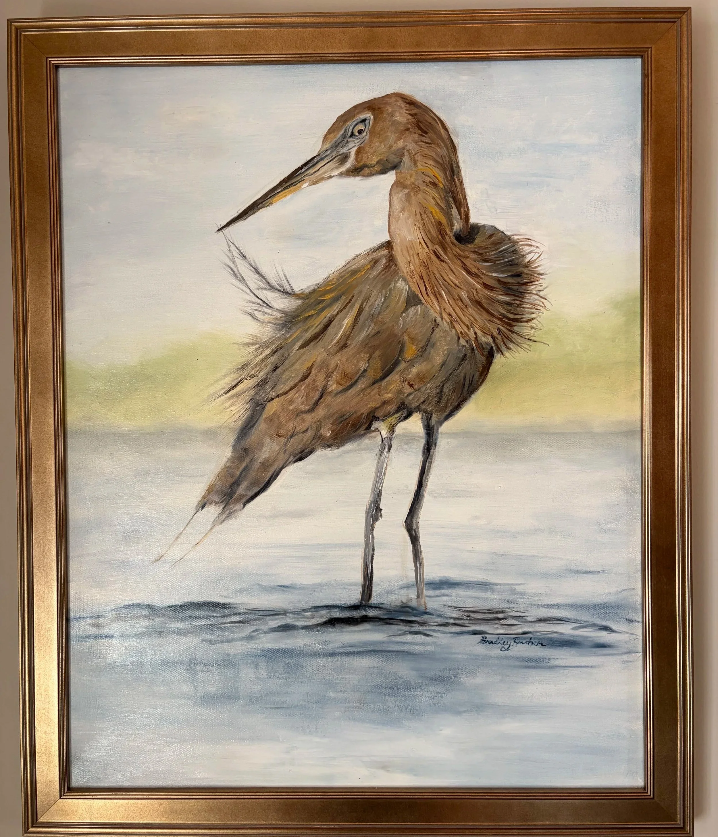 Painting of a brown heron standing by water, with a light sky background. Signed by the artist in the bottom right corner.