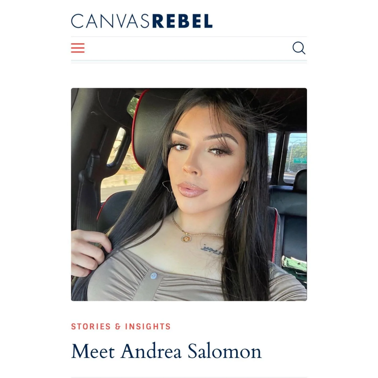 Andrea Salomon with long black hair and makeup taking a selfie inside a vehicle, wearing a light brown top, gold jewelry, and sitting in the passenger seat, featured in Canvas Rebel magazine.