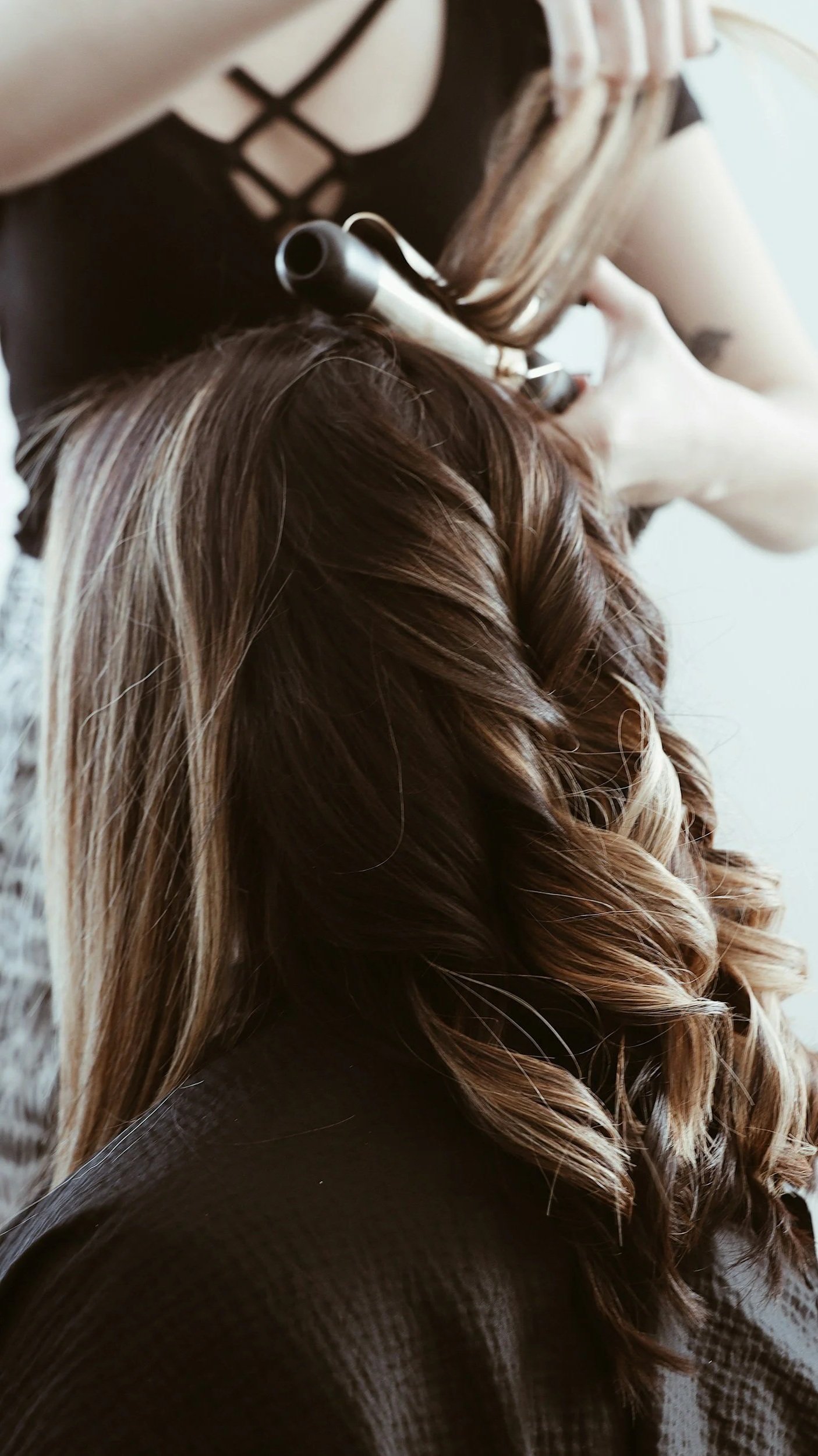 A woman getting her hair done. shot in a moody editorial style