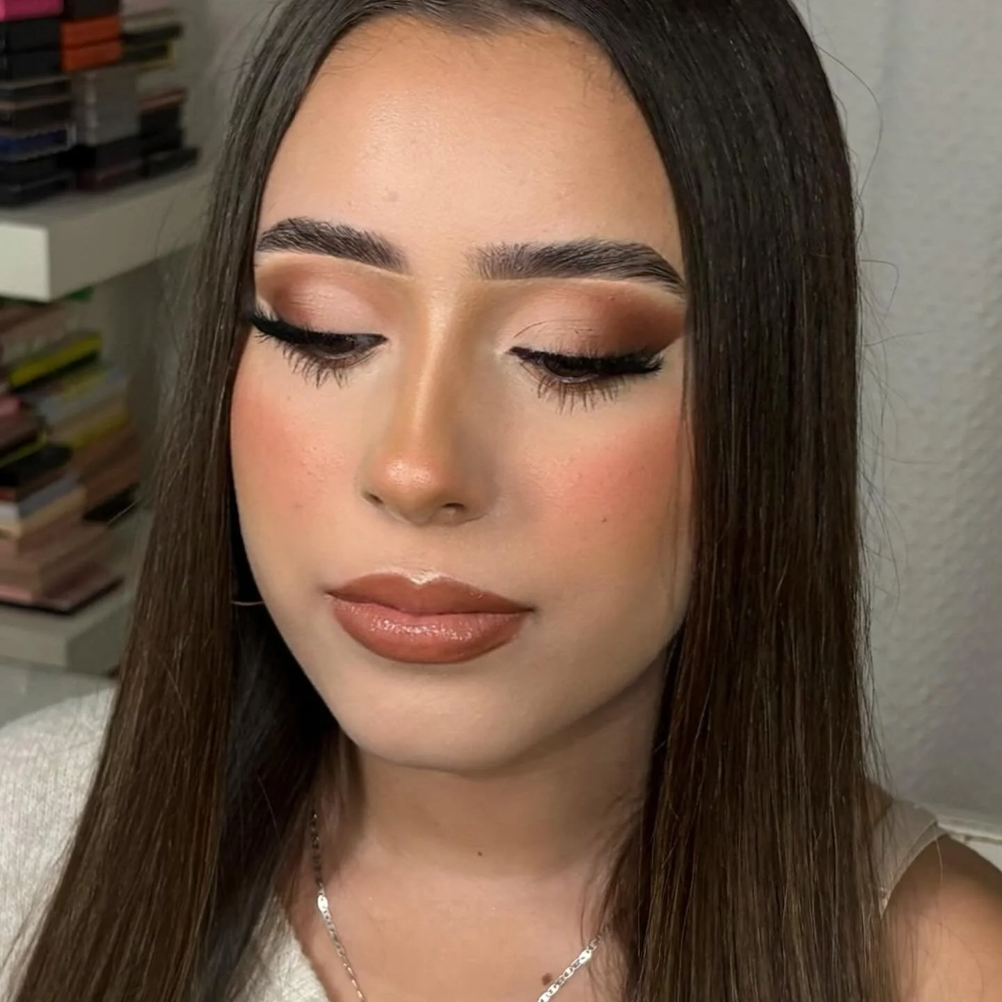 Client wearing neutral cut crease glam with a softly defined crease, bright eyelids, winged liner, and lashes