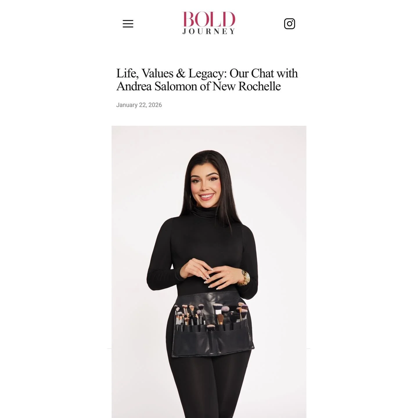 Andrea Salomon of Makeupologyy long dark hair smiling, dressed in black, holding a makeup brush holder, against a plain white background for BOLD Magazine