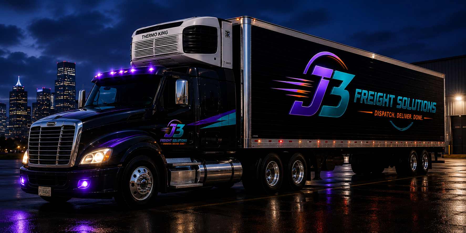 A large black semi-truck with colorful branding, parked on a wet surface at night, city skyline in the background, illuminated logo 'J3 Freight Solutions' with the tagline 'Dispatch. Deliver. Done.'