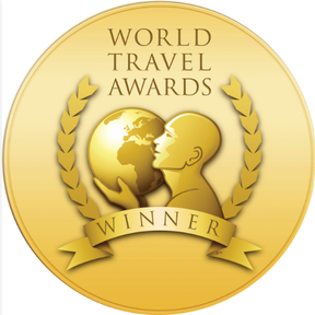Gold emblem for World Travel Awards Winner with a globe, a person's profile, and laurel wreaths.