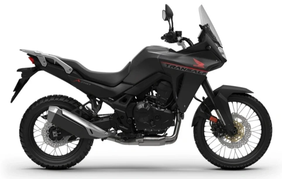 Black Honda Transalp motorcycle with a windscreen, off-road tires, and rugged design.
