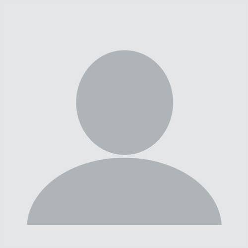 Placeholder avatar silhouette of a person with a round head and shoulders on a gray background.