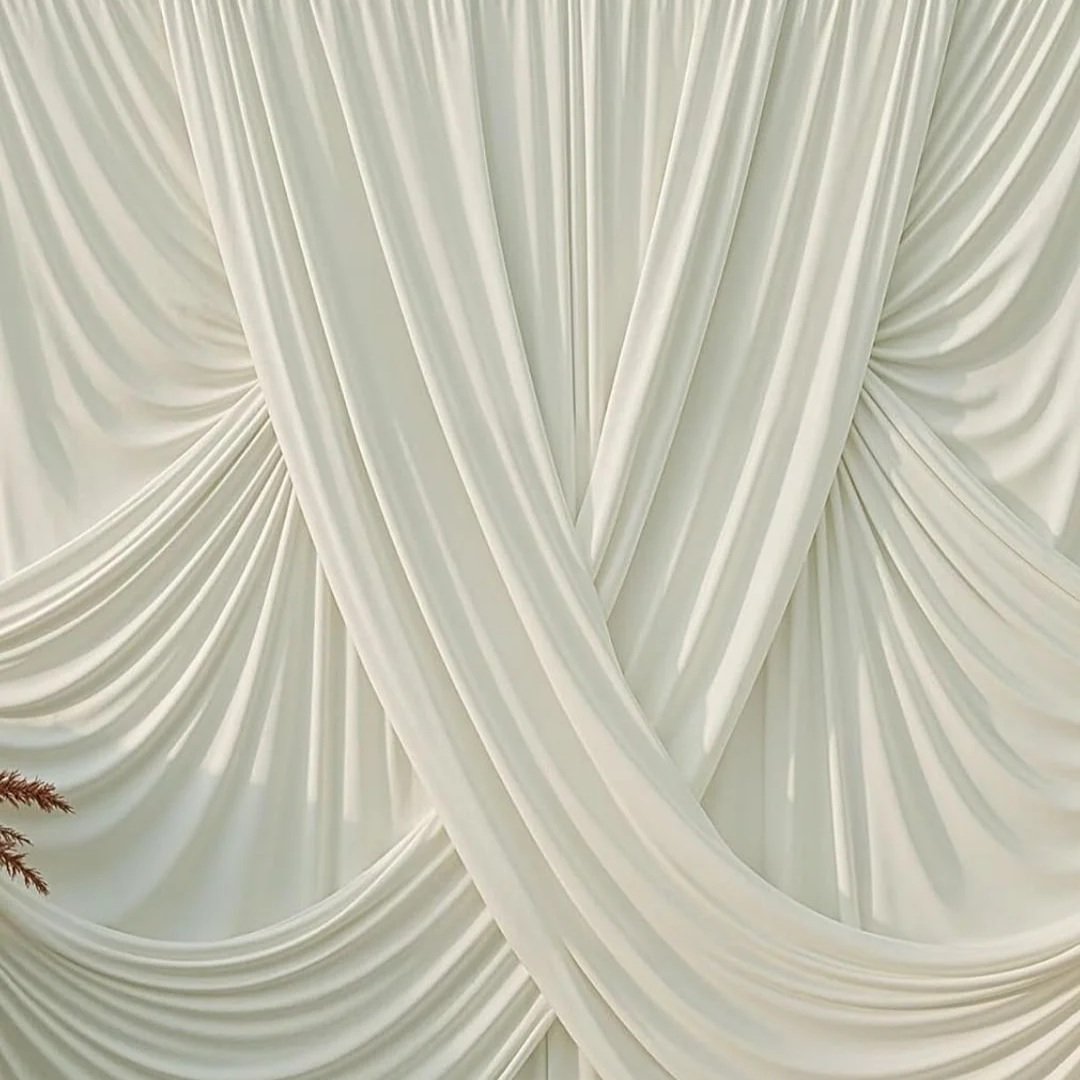 Cream-colored draped curtain with gathered fabric design.