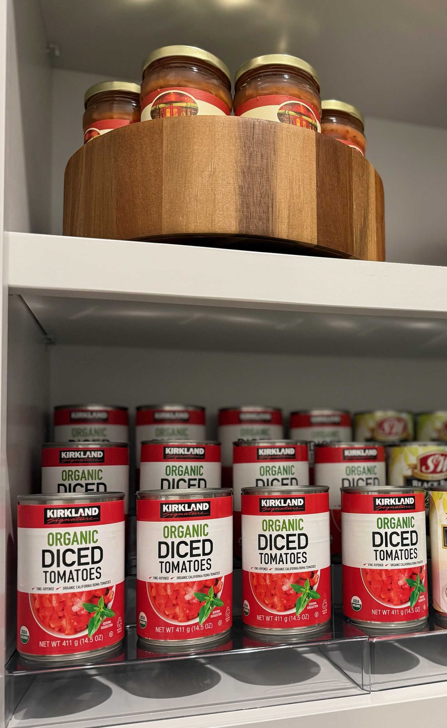 Organized pantry shelf with canned goods neatly lined up