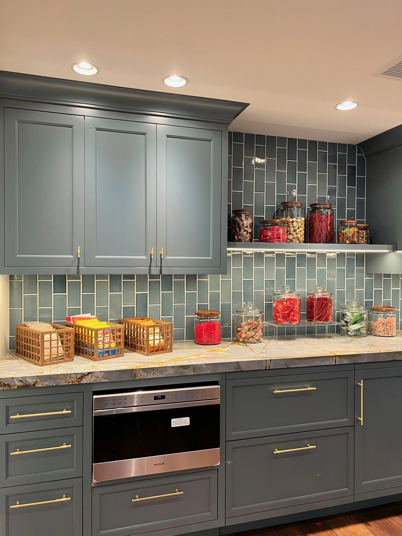 Organized kitchen counter with glass canisters and woven baskets