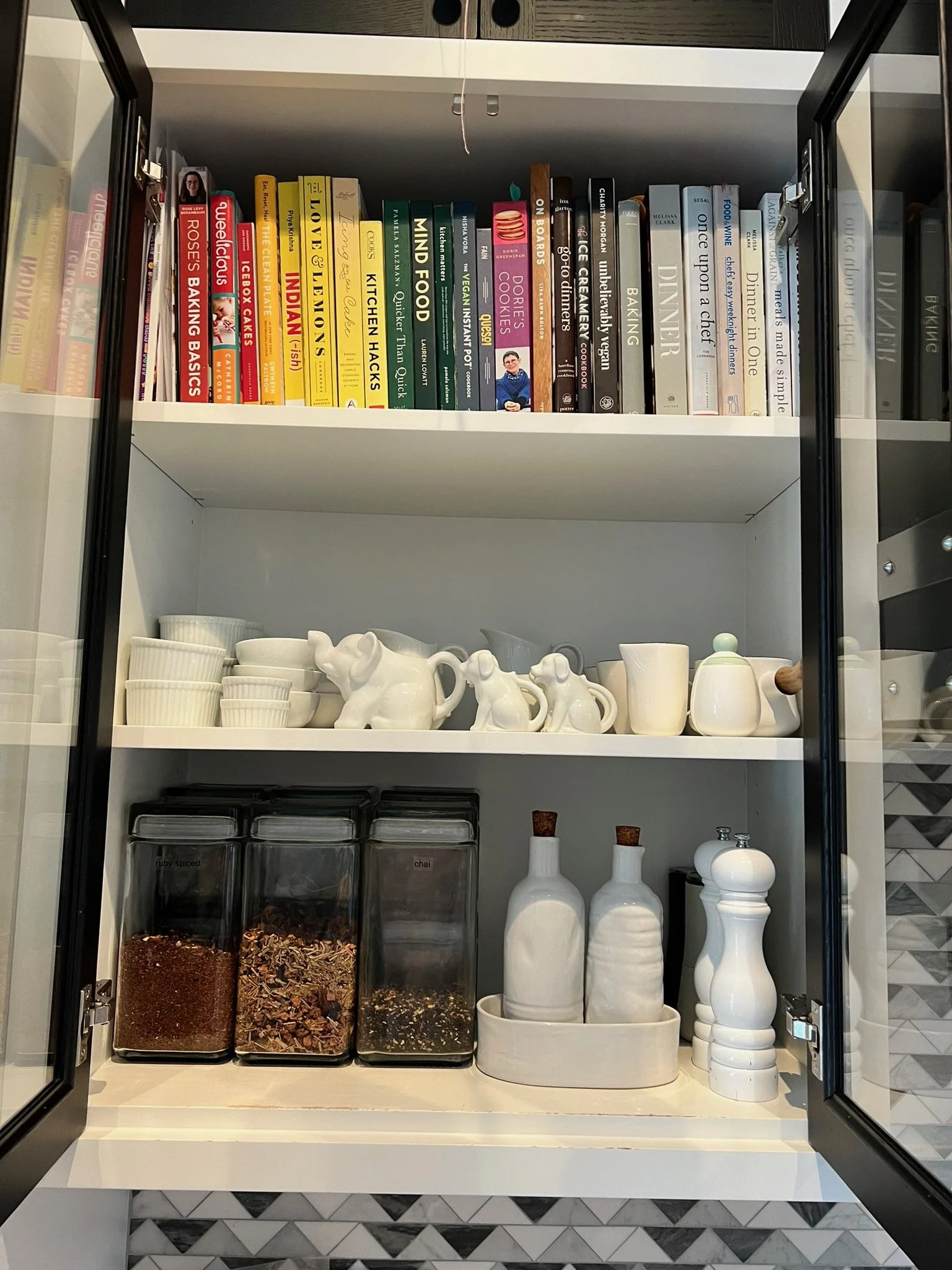 Organized butler's pantry with cookbooks and glass canisters
