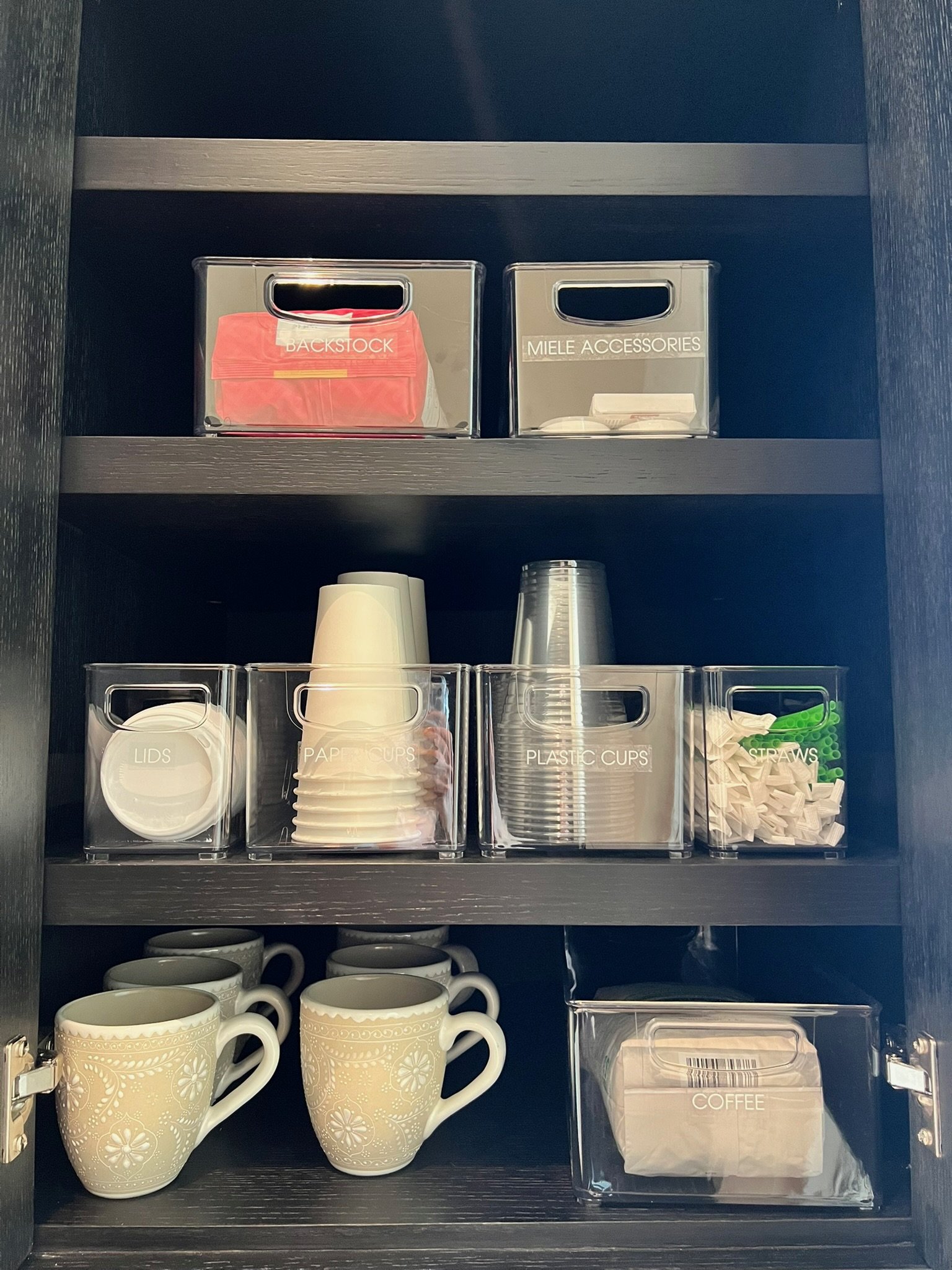 Custom pantry shelving with labeled bins and glass storage