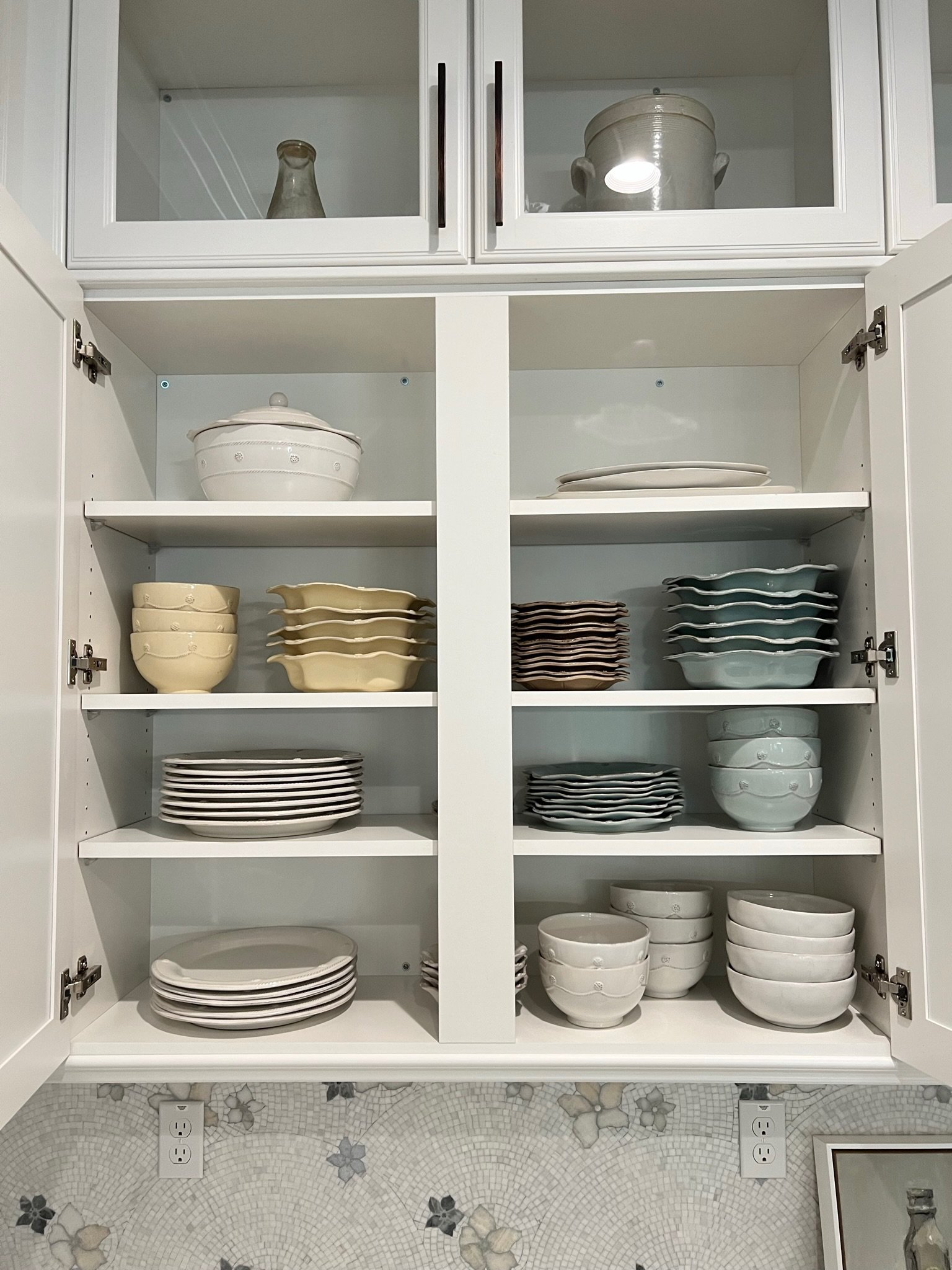 Organized cabinet with neatly arranged dishes and bowls