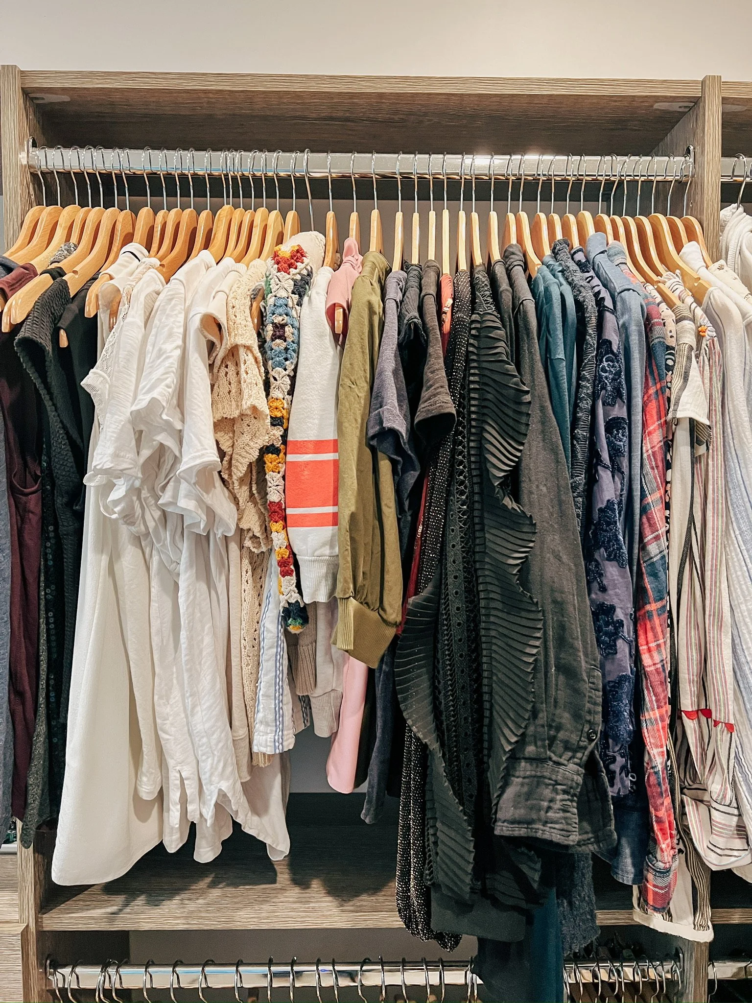 Organized closet with hanging clothing, professionally arranged