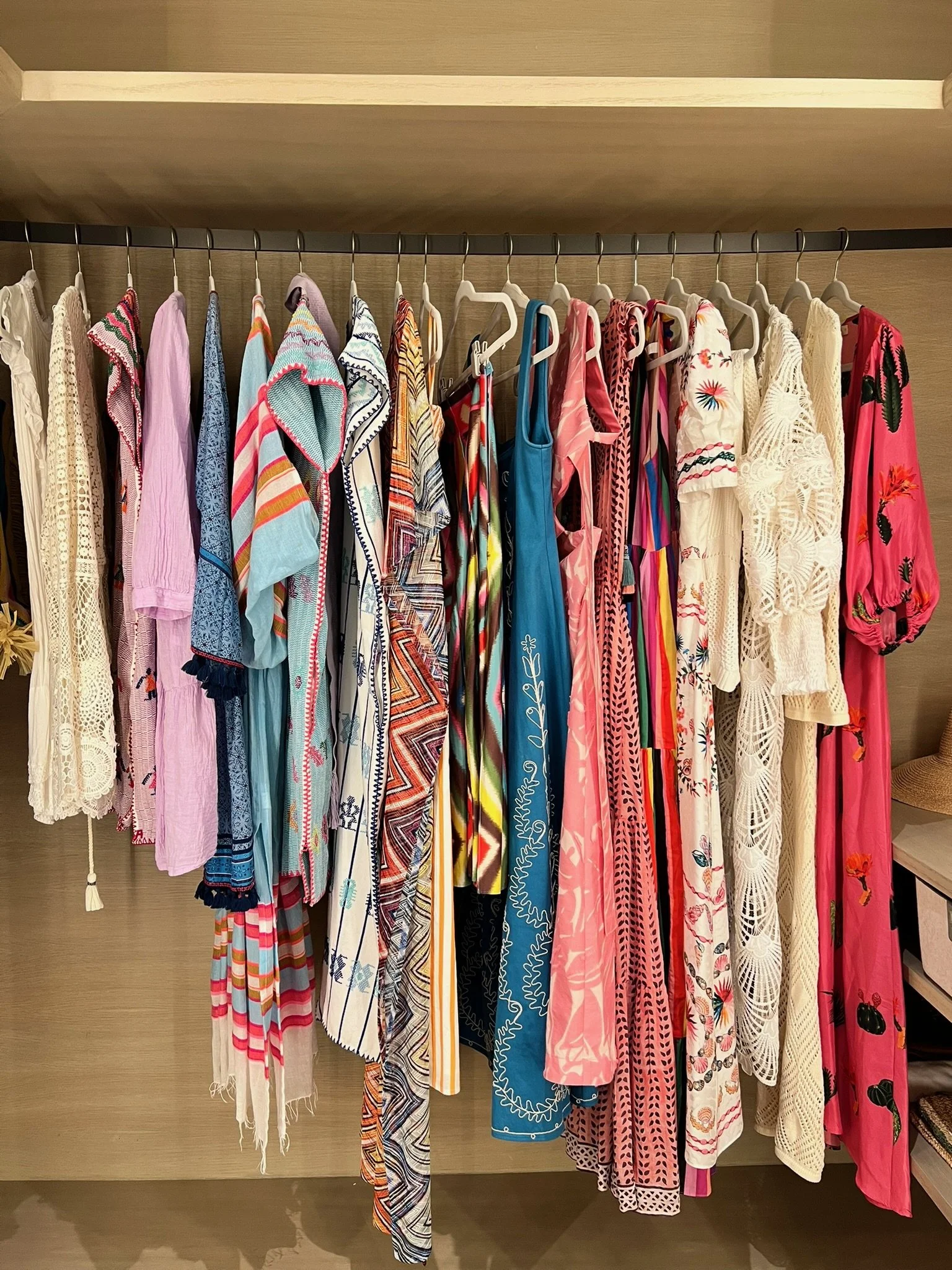 Custom closet with color-coordinated hanging clothing