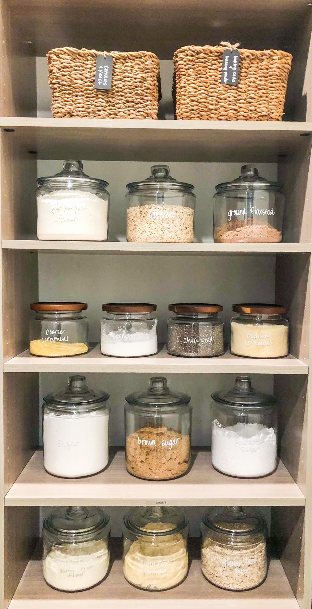 Organized pantry shelving with matching glass canisters