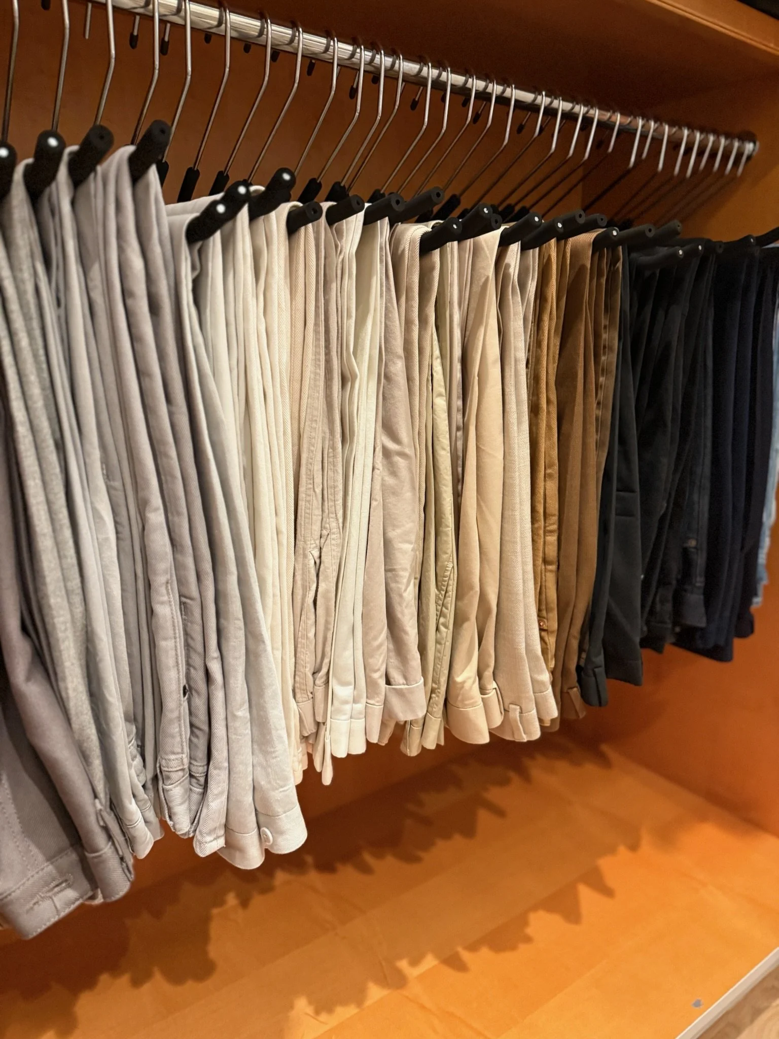 Neatly organized closet with color-coordinated clothing