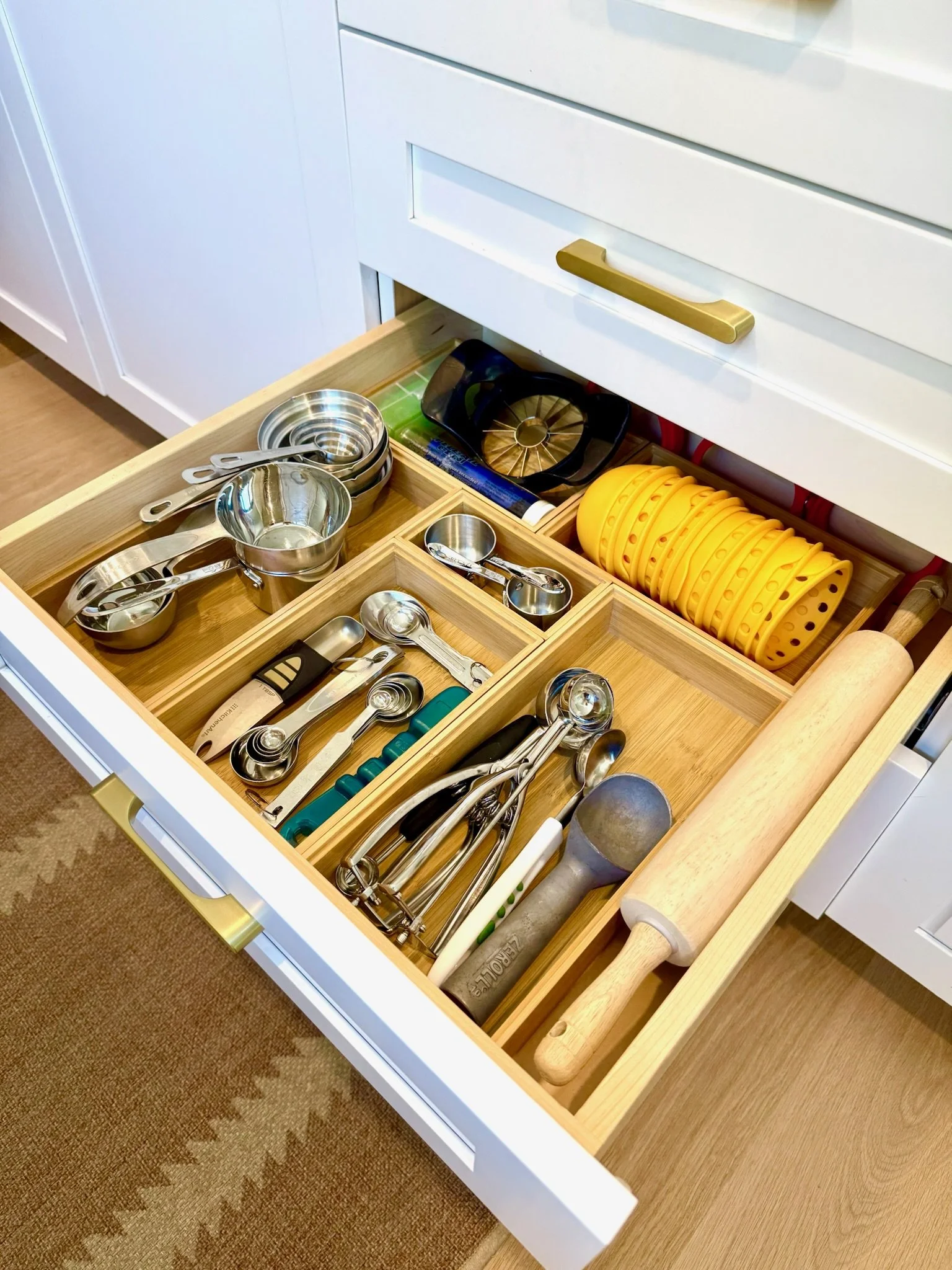 Organized kitchen drawer with dividers for utensils and measuring cups