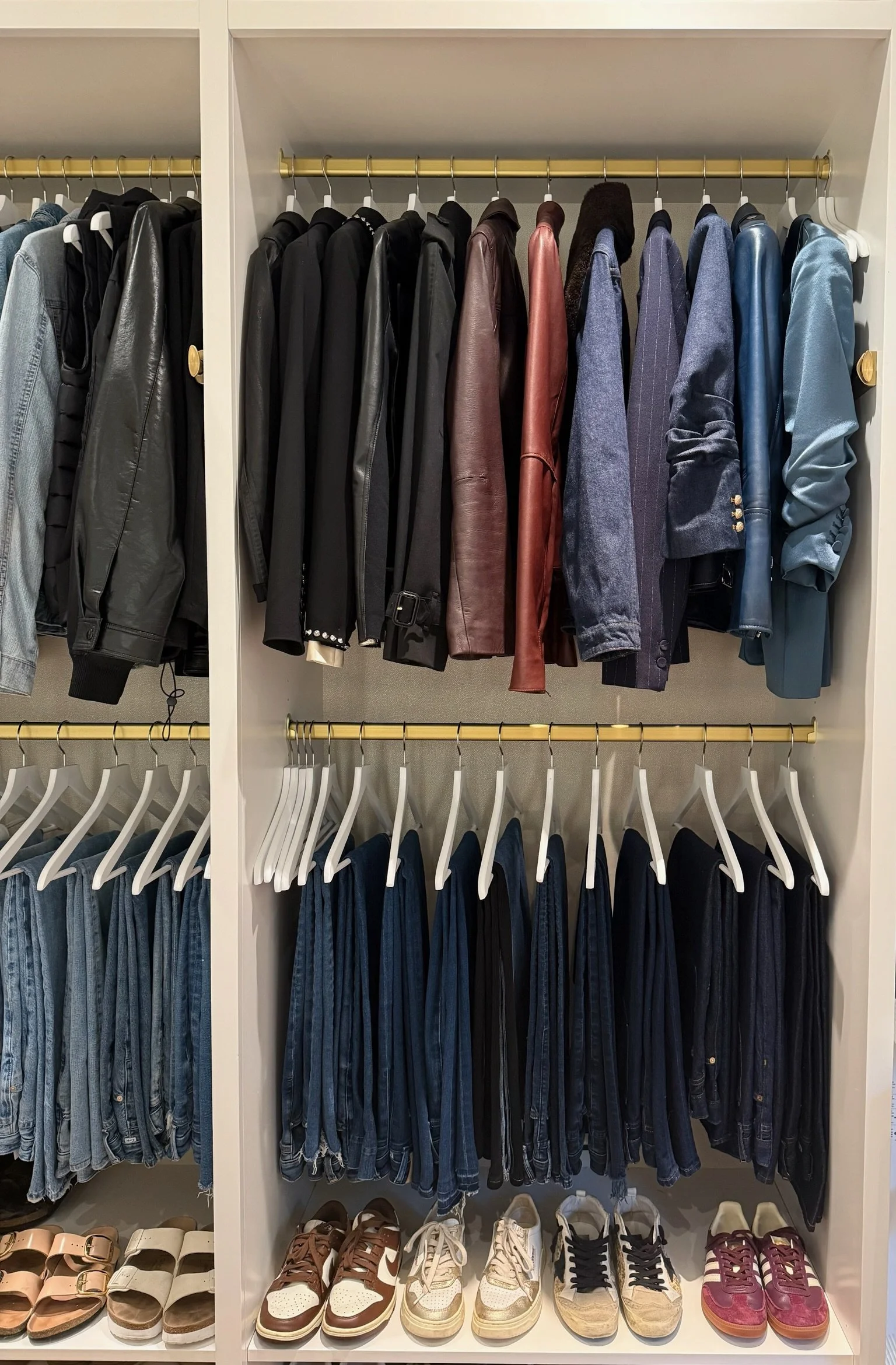 Organized closet with tailored jackets and hanging garments