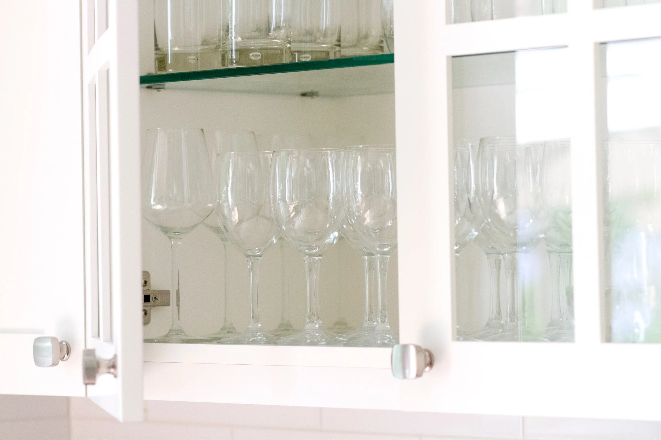 Organized glass cabinet with stemware and wine glasses