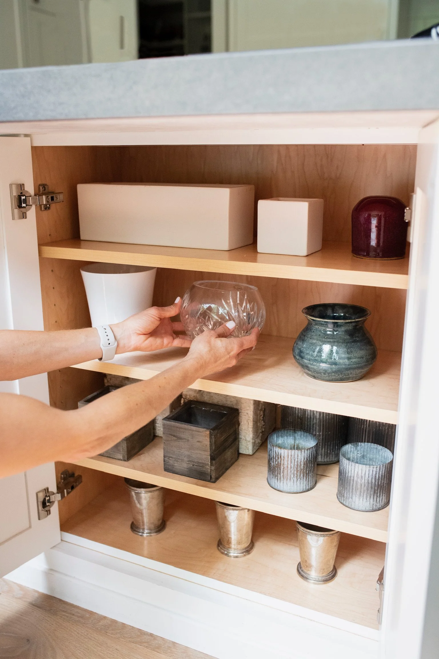 Organized cabinet with neatly arranged containers and glassware