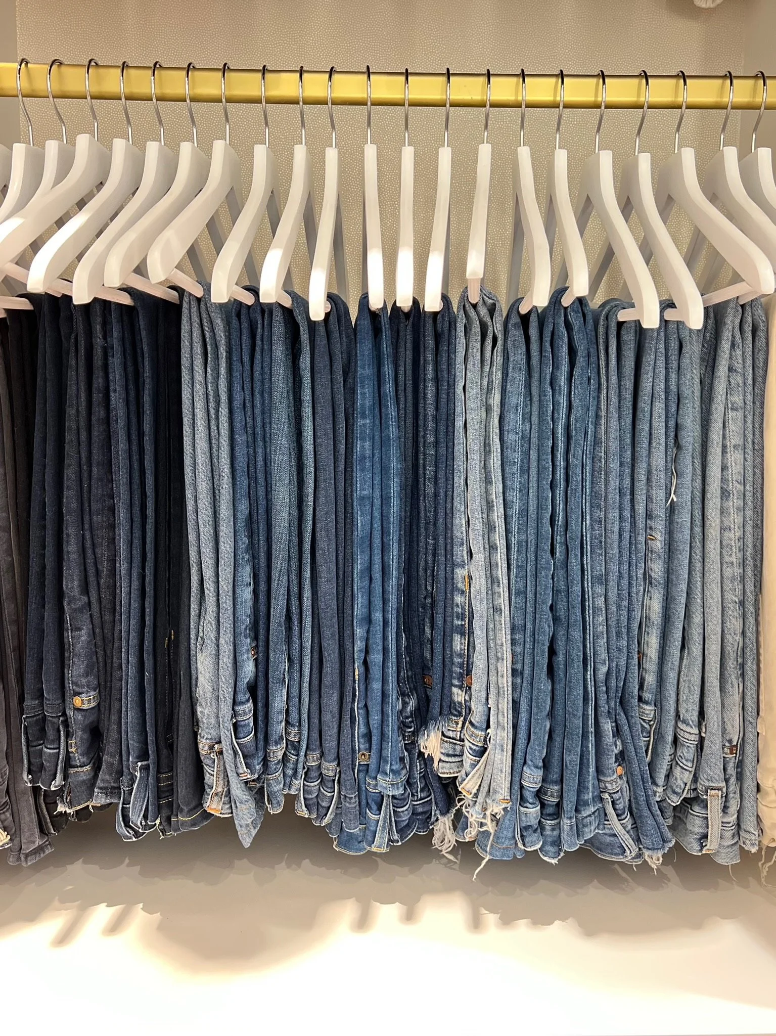 Custom closet with neatly hung, organized denim