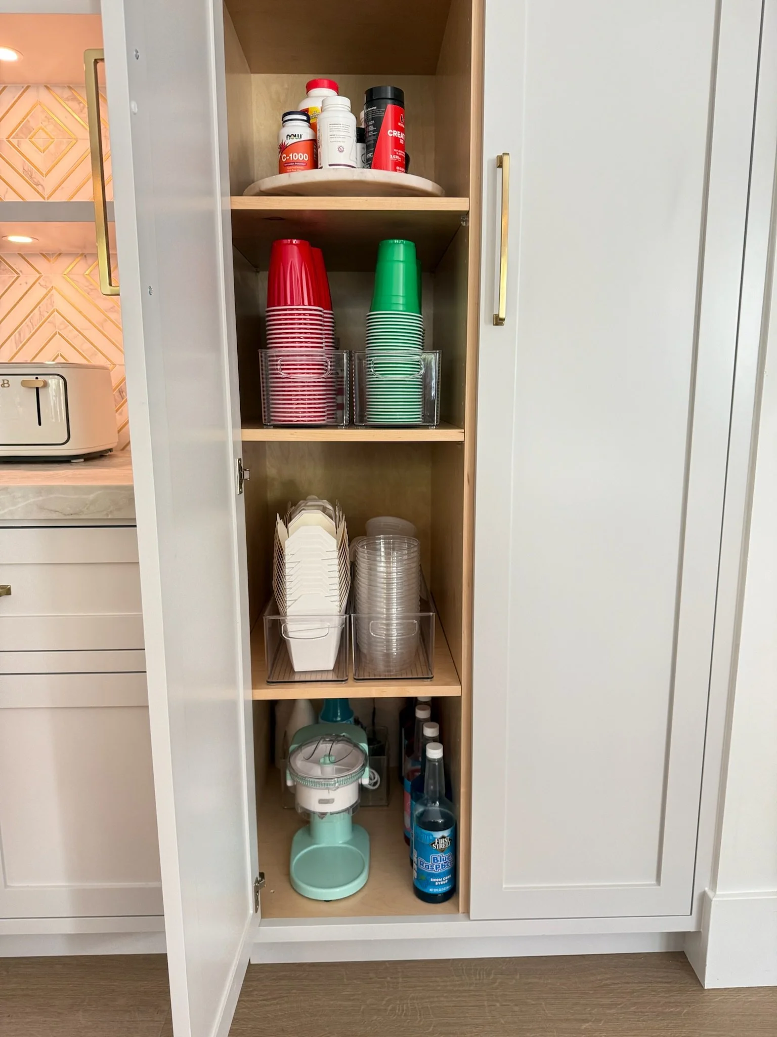 Custom closet shelving with organized party cups and disposable items