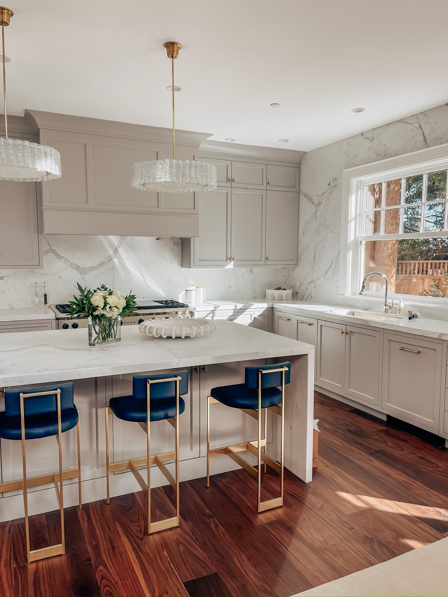 Bright, organized kitchen with marble island and bar seating