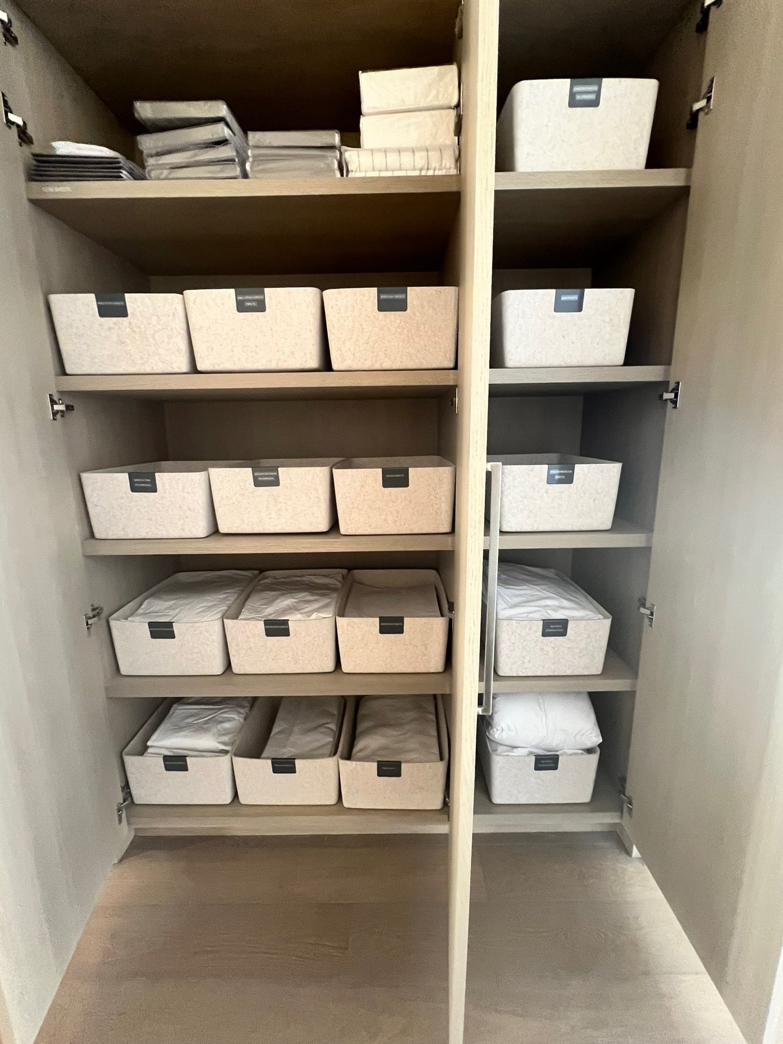 Organized pantry with labeled woven storage baskets