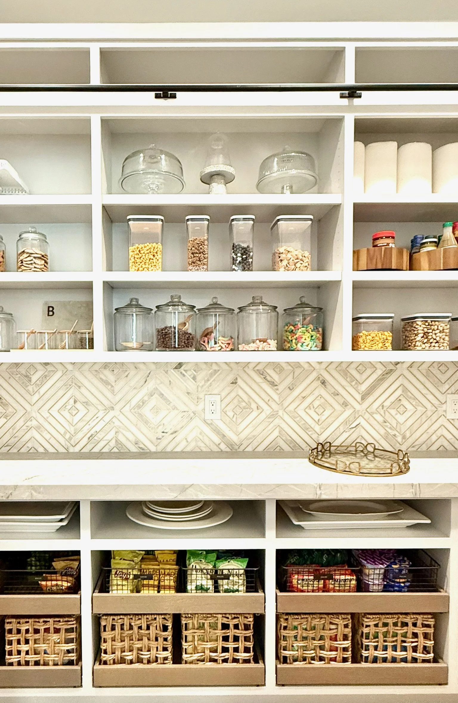 Custom pantry shelving with labeled glass storage jars
