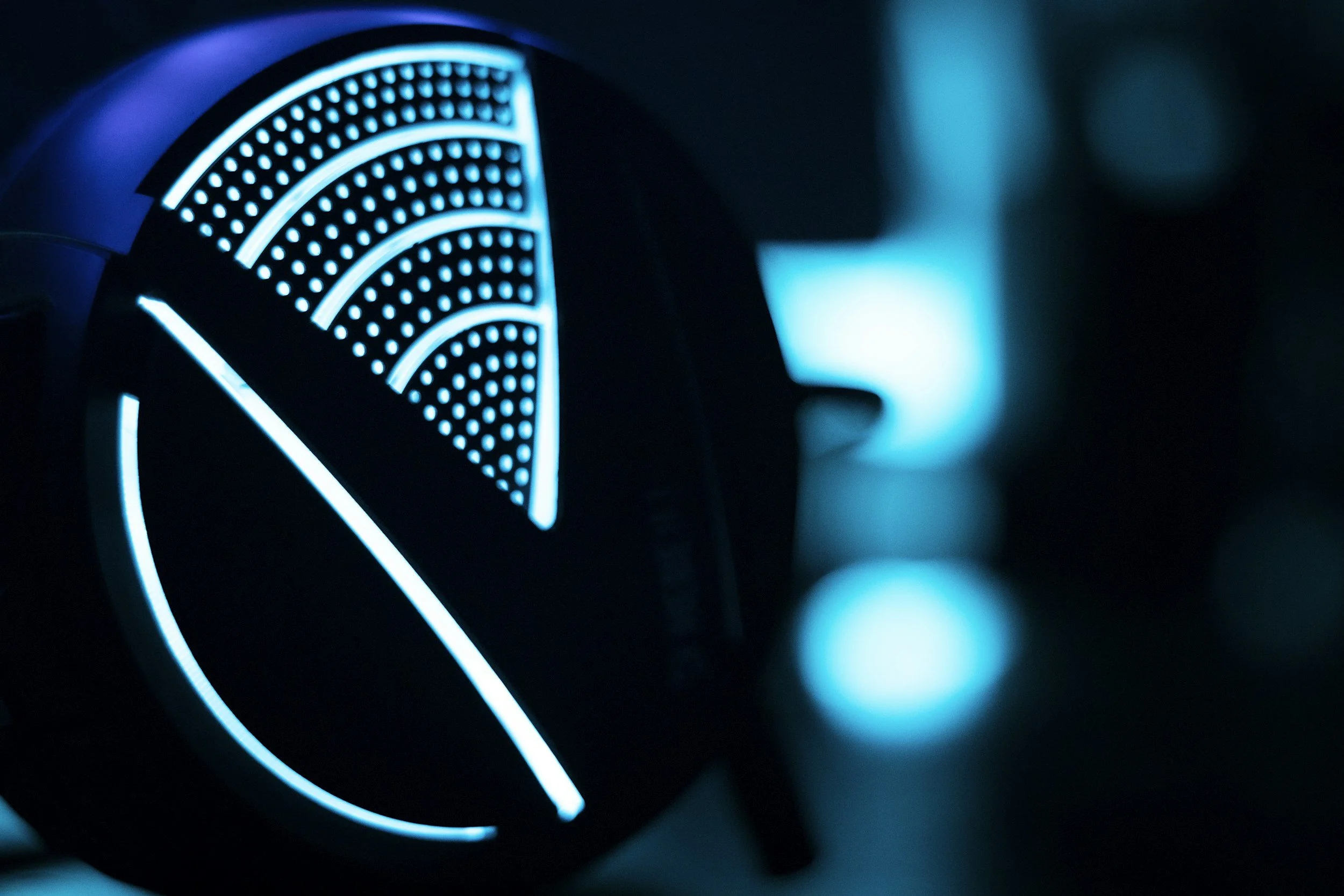 Close-up of a studio microphone lit in deep blue.