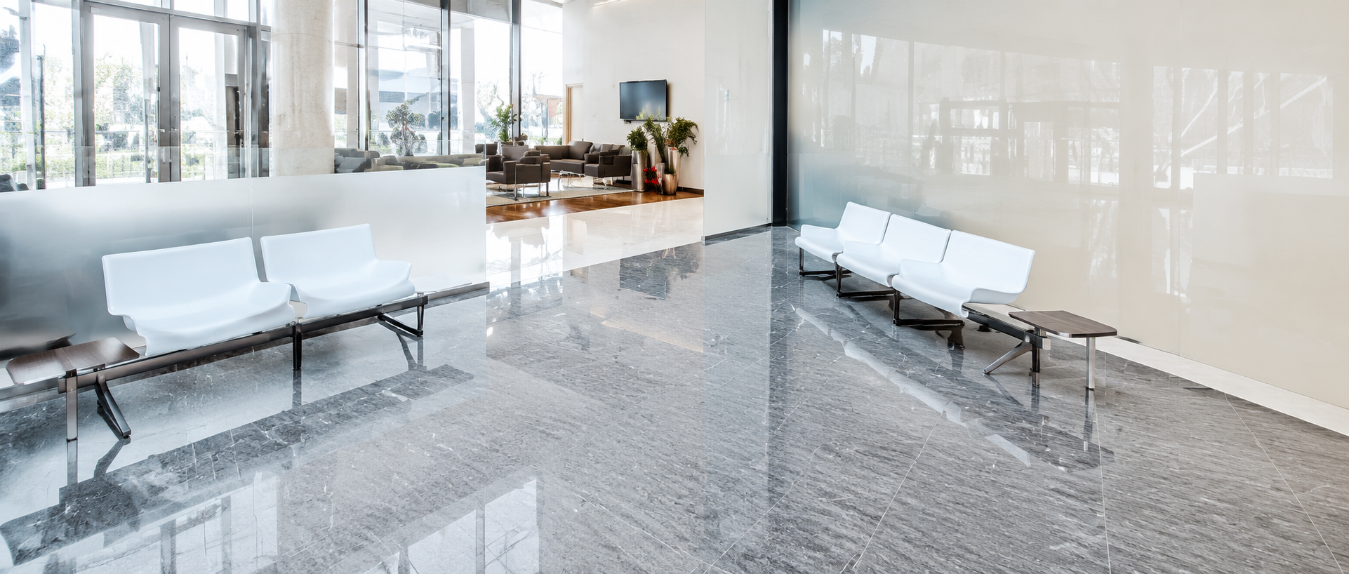Bright, spotless medical office lobby featuring polished stone flooring and a clean waiting area, reflecting the results of professional commercial cleaning services for healthcare facilities.