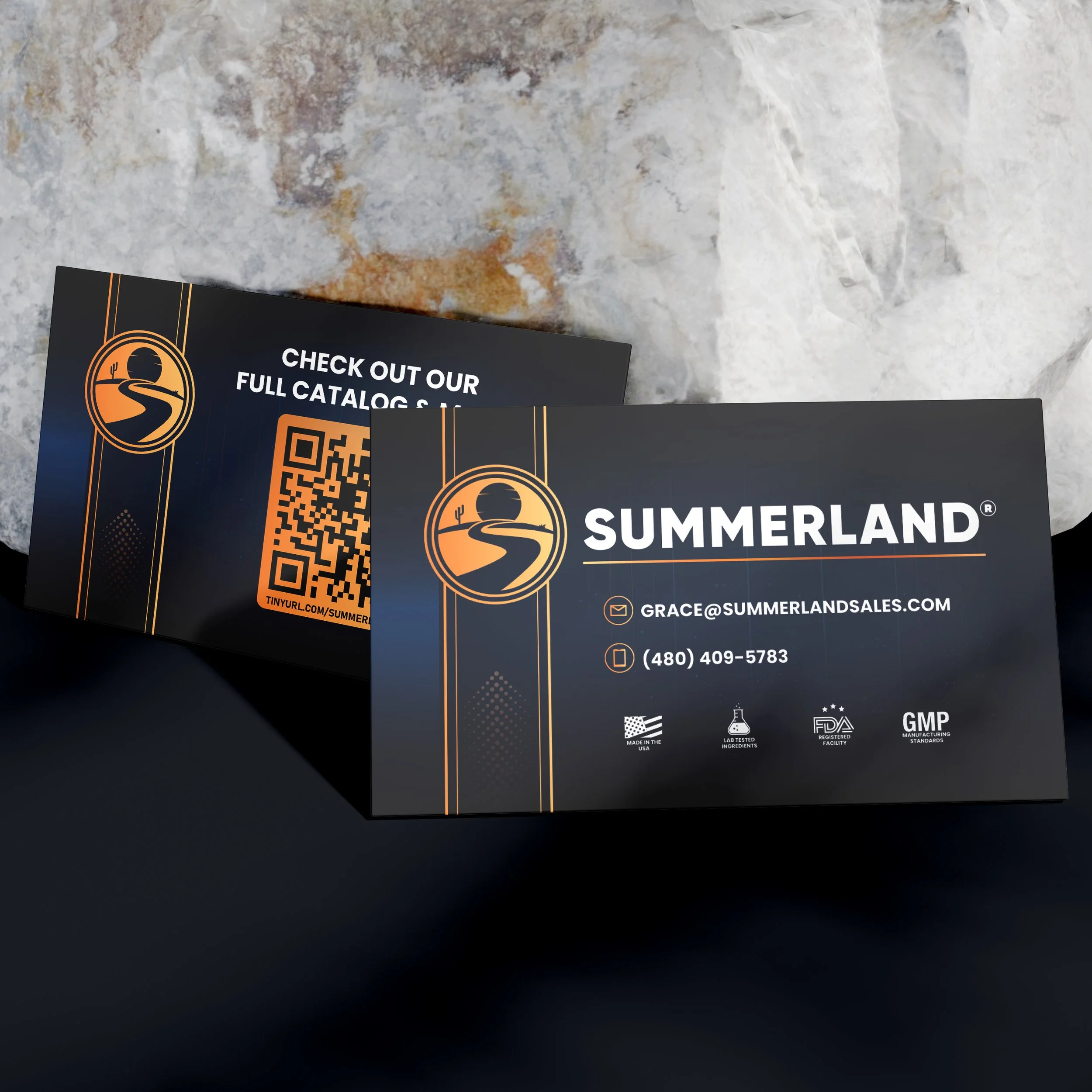 A dark-colored card or flyer displaying a logo with a winding road and sunset, along with contact information including an email address, phone number, and icons indicating country of manufacture, lab testing, FDA registration, and GMP standards.