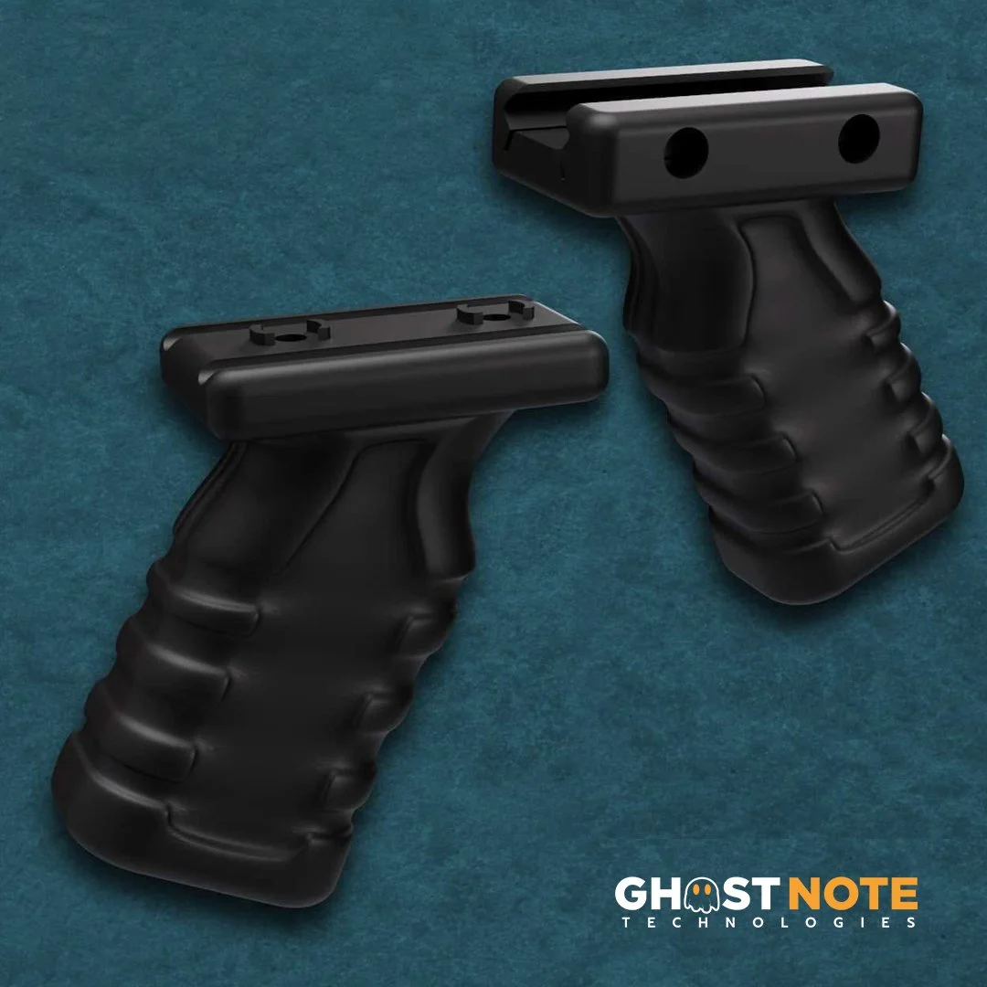 Two black firearm grip controllers with ergonomic grips placed on a teal surface, with a GhostNote Technologies logo at the bottom right corner.