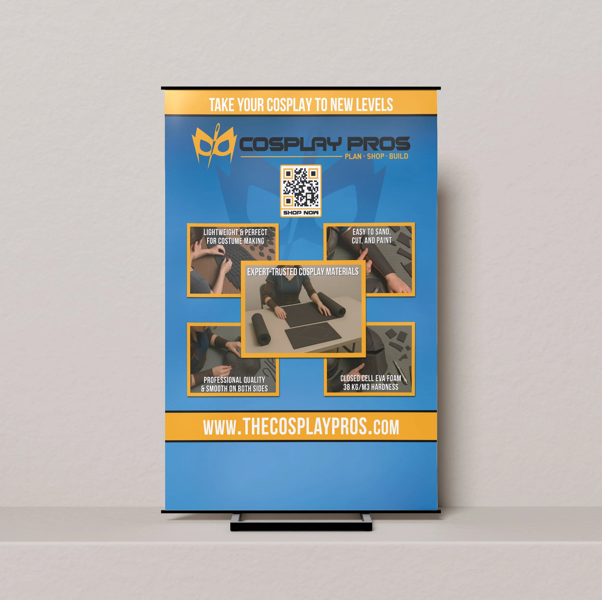 A roll-up banner advertising cosplay materials with a blue background, yellow accents, and images of cosplay foam crafting, including a person measuring foam and foam pieces. The banner features the website www.thecosplaypros.com at the bottom.