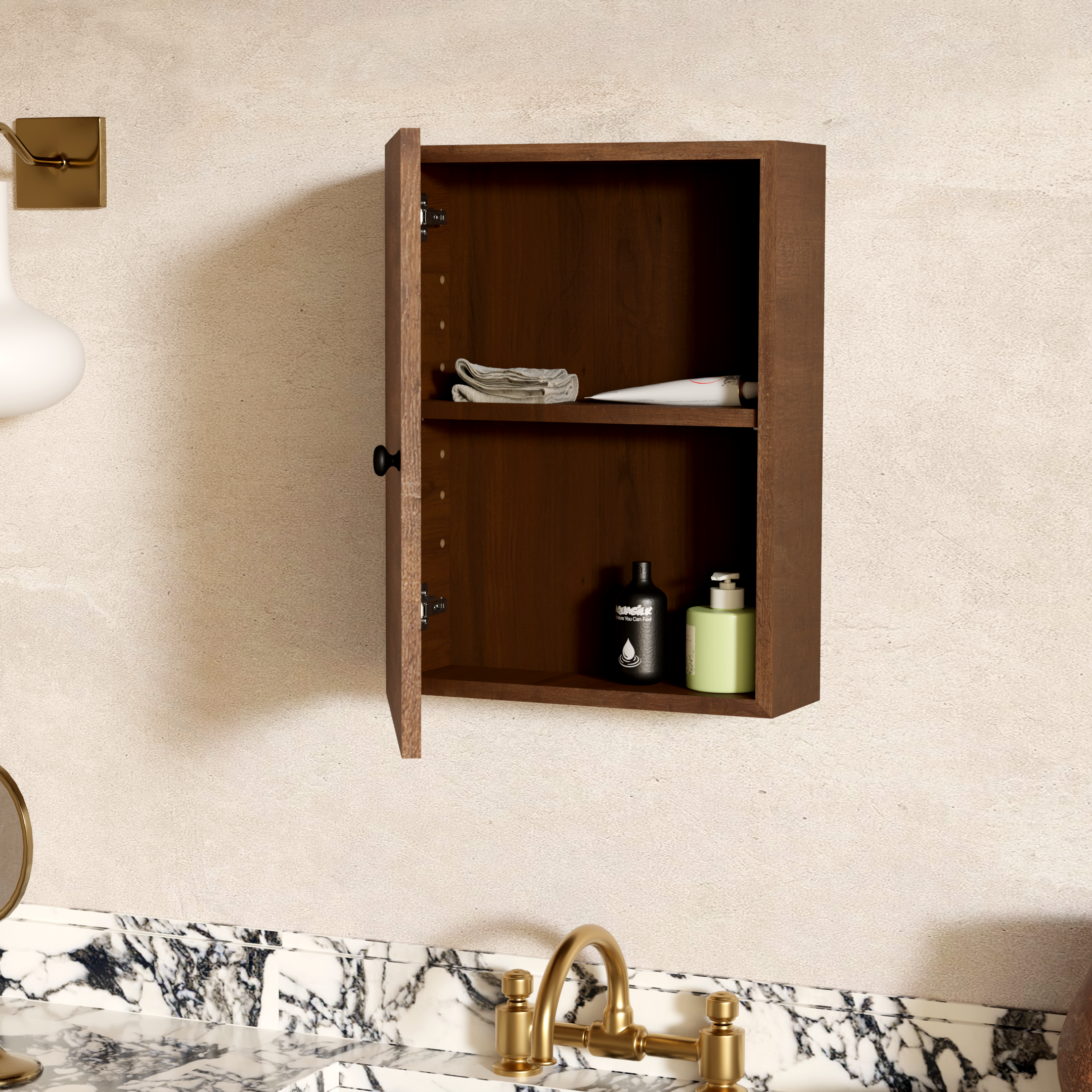 Kitchen sink with a marble countertop, gold faucet, and an open wooden cabinet above, containing folded towels and bottles of cleaning products, with a beige wall behind.