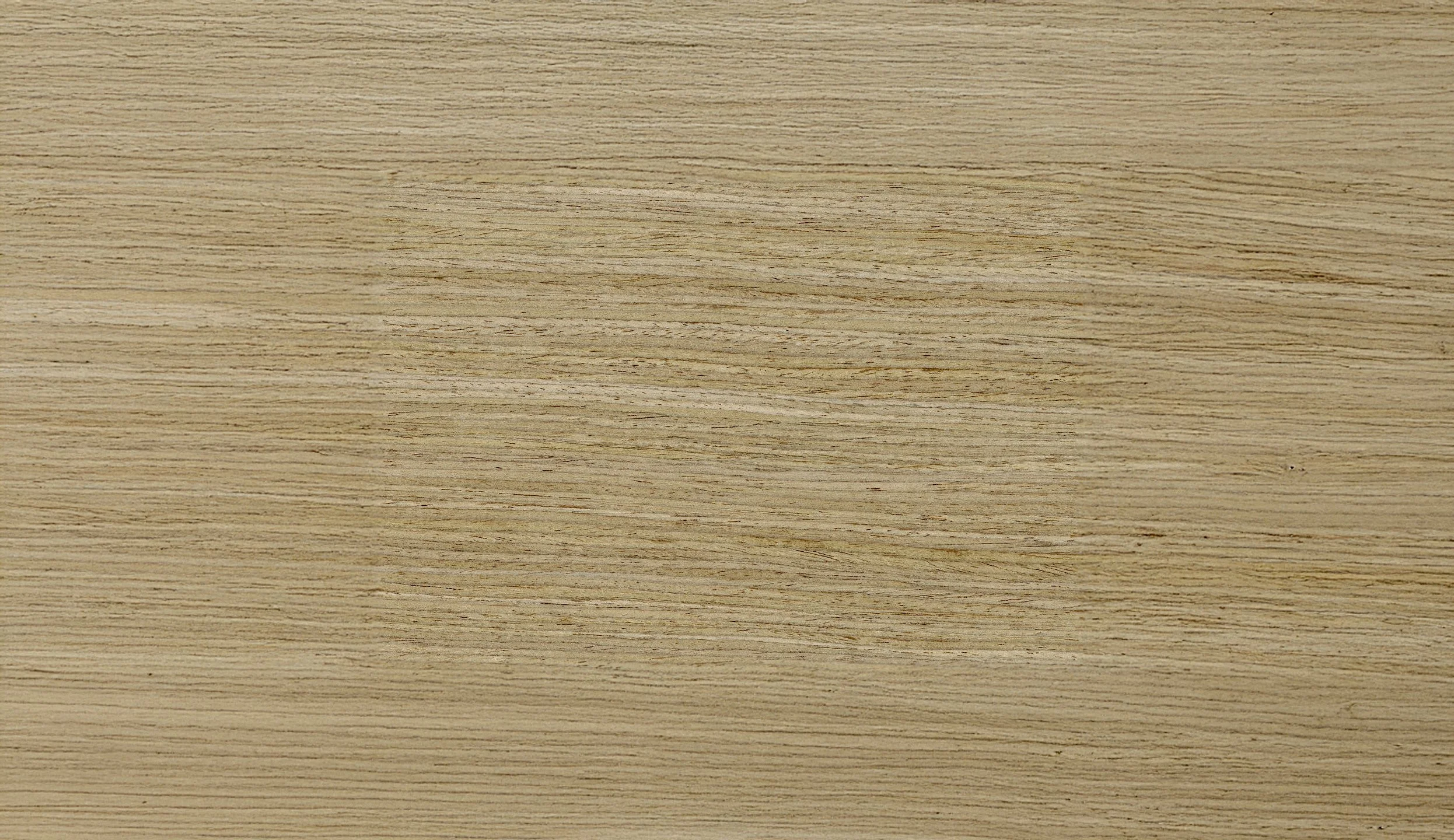 Close-up image of a light-colored wooden surface with horizontal grain patterns.