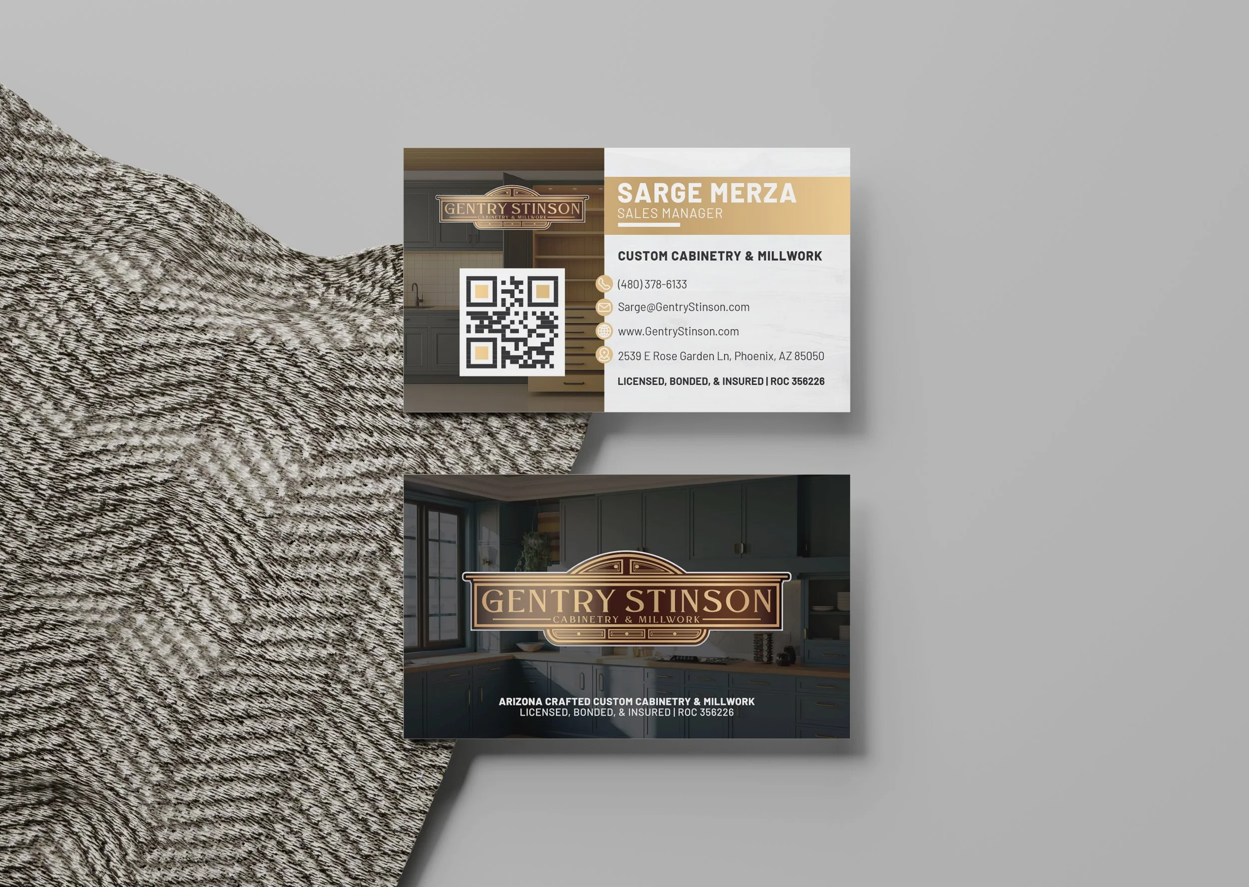 A business card for Sarge Merza, a sales manager at Gentry Stinson Cabinetry & Millwork. The card features a QR code, contact information, and a background image of a kitchen. The card emphasizes custom cabinetry and millwork, with licensing details.